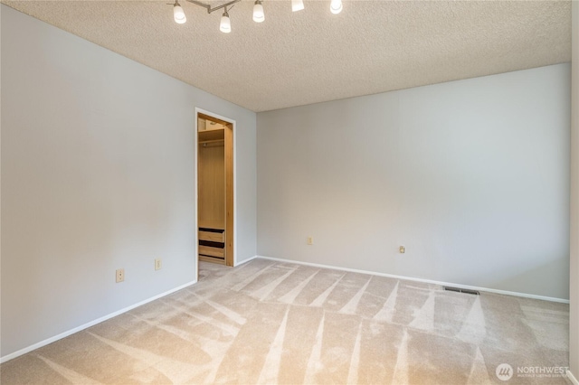 2913 27th St SE, Auburn, WA 98092 - carpeted spare room with a textured ceiling and baseboards