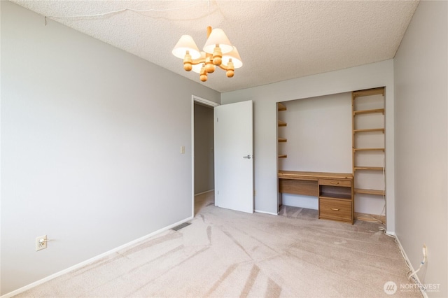 2913 27th St SE, Auburn, WA 98092 - unfurnished bedroom featuring light carpet, a desk, a chandelier, and a textured ceiling