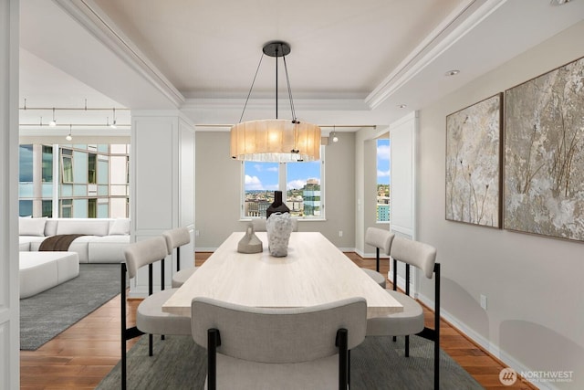 2600 2nd Ave Unit 2501, Seattle, WA 98121 - dining space featuring a tray ceiling and wood finished floors