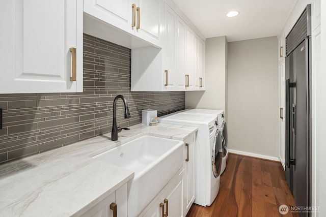 2600 2nd Ave Unit 2501, Seattle, WA 98121 - laundry area featuring cabinet space, washing machine and dryer, dark wood-style flooring, and recessed lighting