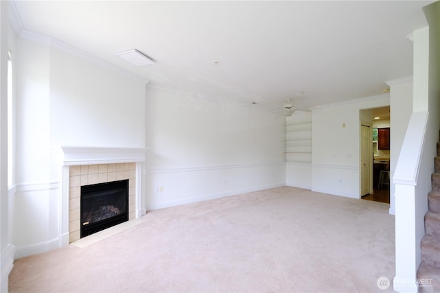 28710 S 34th Ave Unit B5, Auburn, WA 98001 - unfurnished living room featuring carpet flooring, a ceiling fan, a tiled fireplace, and ornamental molding