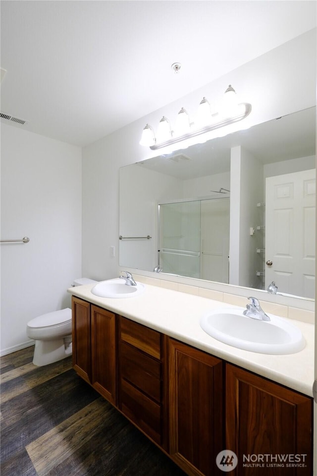 28710 S 34th Ave Unit B5, Auburn, WA 98001 - bathroom with double vanity, wood finished floors, and a shower with shower door