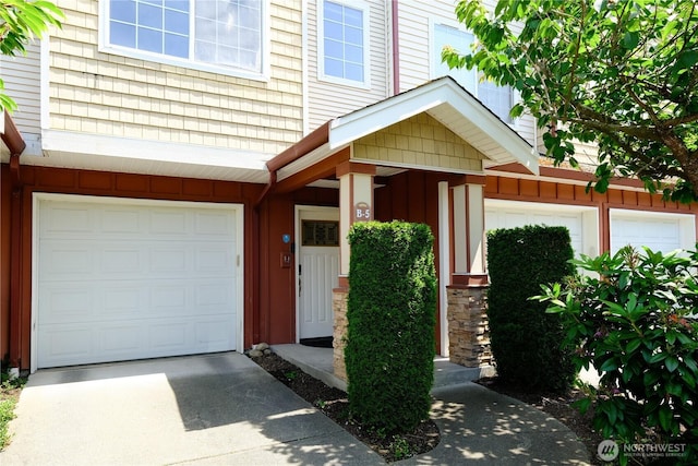 28710 S 34th Ave Unit B5, Auburn, WA 98001 - view of exterior entry featuring a garage, board and batten siding, and driveway