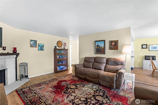 1211 N 8th St Unit 4, Mount Vernon, WA 98273 - living room with wood finished floors, a fireplace, and a textured ceiling