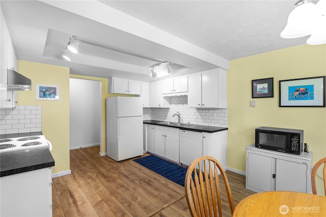 1211 N 8th St Unit 4, Mount Vernon, WA 98273 - kitchen featuring white appliances, wall chimney exhaust hood, dark countertops, and a tray ceiling