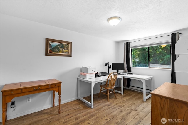 1211 N 8th St Unit 4, Mount Vernon, WA 98273 - home office featuring wood finished floors, a textured ceiling, and baseboard heating