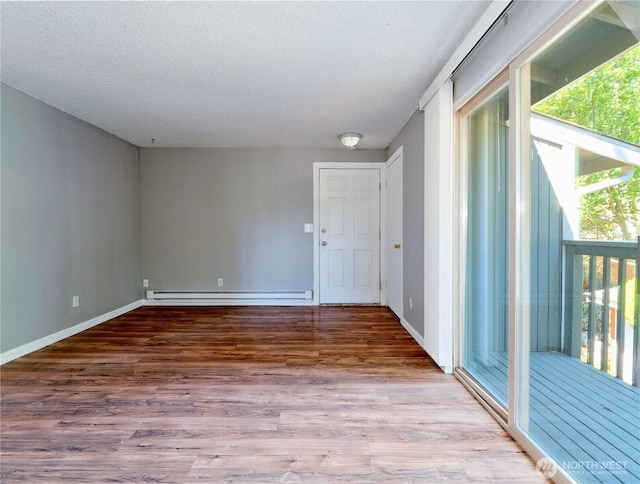 2716 S 256th Pl, Kent, WA 98032 - empty room featuring a baseboard radiator, wood finished floors, and a textured ceiling