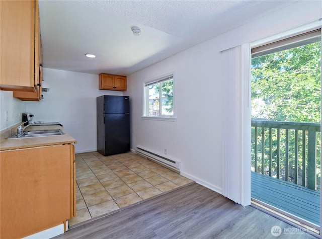 2716 S 256th Pl, Kent, WA 98032 - kitchen featuring baseboard heating, freestanding refrigerator, light wood finished floors, and light countertops