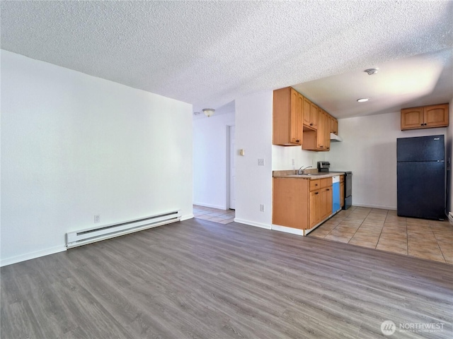 2716 S 256th Pl, Kent, WA 98032 - kitchen with freestanding refrigerator, baseboard heating, range, light wood-style floors, and under cabinet range hood