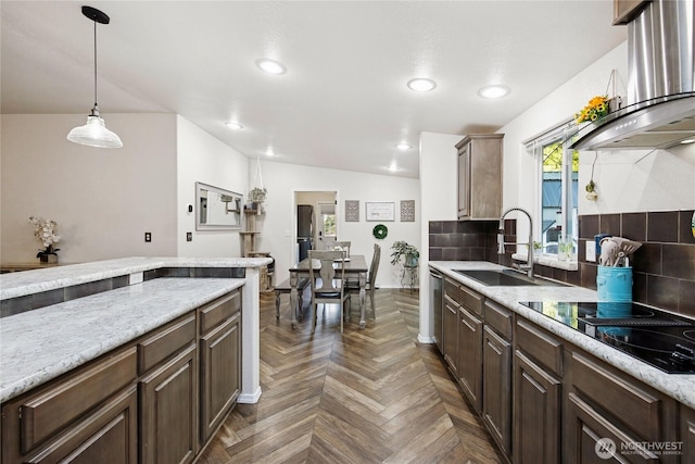 29 Sherburne Rd, Sequim, WA 98382 - kitchen with wall chimney exhaust hood, decorative backsplash, black electric stovetop, recessed lighting, and decorative light fixtures