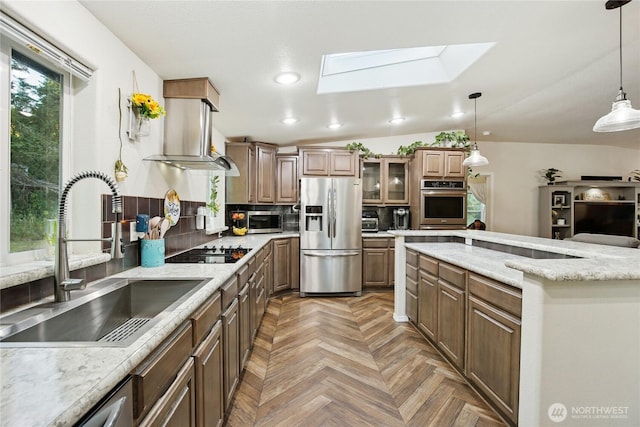 29 Sherburne Rd, Sequim, WA 98382 - kitchen with stainless steel appliances, island exhaust hood, a skylight, backsplash, and pendant lighting