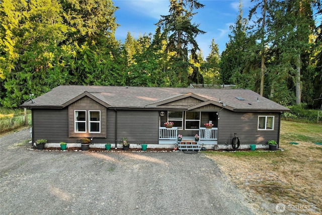 29 Sherburne Rd, Sequim, WA 98382 - view of front of home featuring covered porch, roof with shingles, and driveway