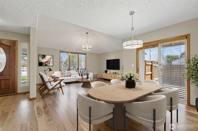 13019 NE 96th Way, Vancouver, WA 98682 - dining space featuring a textured ceiling, a chandelier, light wood finished floors, and lofted ceiling