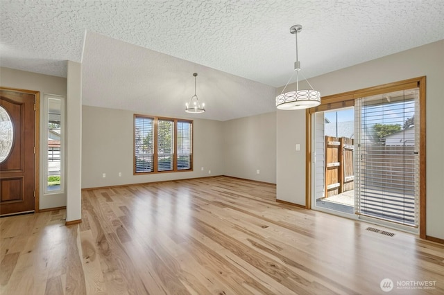 13019 NE 96th Way, Vancouver, WA 98682 - entryway featuring a textured ceiling, light wood finished floors, plenty of natural light, and a chandelier