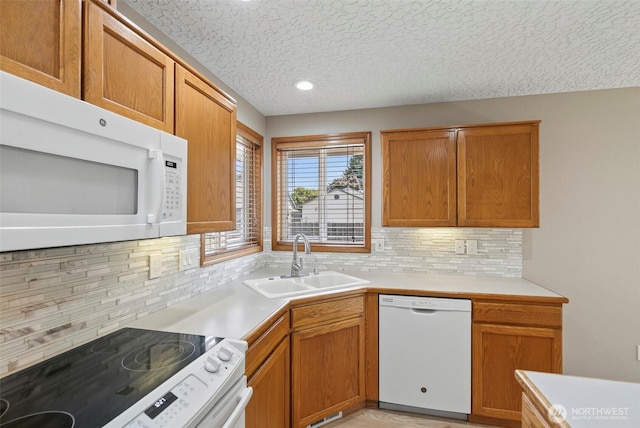 13019 NE 96th Way, Vancouver, WA 98682 - kitchen featuring white appliances, decorative backsplash, a textured ceiling, light countertops, and recessed lighting