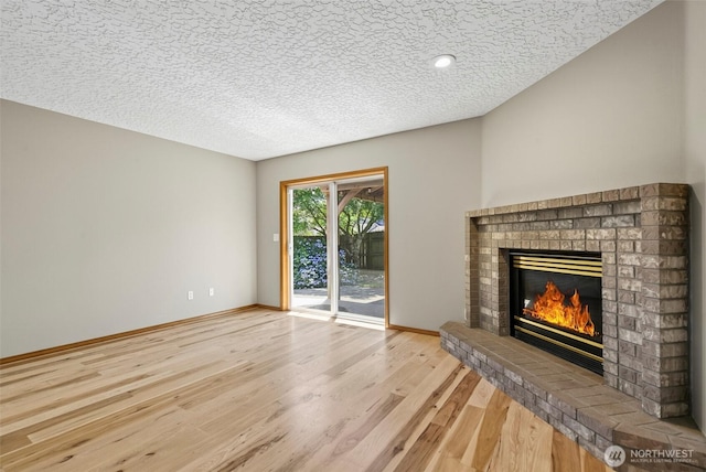 13019 NE 96th Way, Vancouver, WA 98682 - unfurnished living room with wood finished floors, a fireplace, a textured ceiling, and recessed lighting