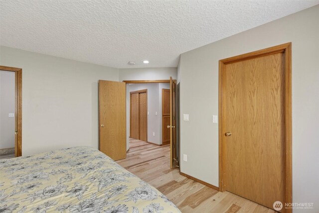 13019 NE 96th Way, Vancouver, WA 98682 - bedroom featuring light wood-type flooring, a textured ceiling, and recessed lighting