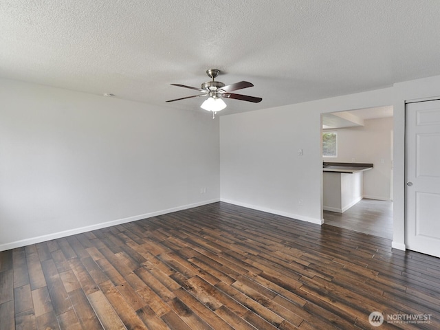 2705 181st Ave E, Lake Tapps, WA 98391 - spare room featuring dark wood-style floors, a ceiling fan, and a textured ceiling