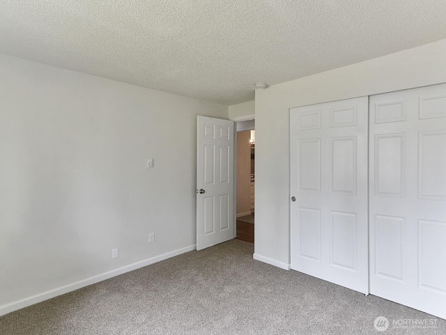 2705 181st Ave E, Lake Tapps, WA 98391 - unfurnished bedroom with carpet flooring, a closet, and a textured ceiling