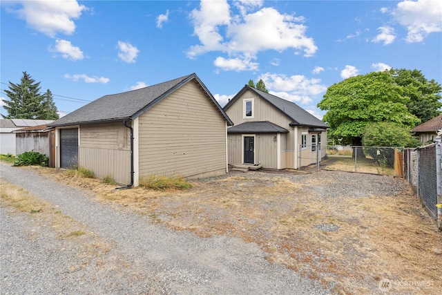 3738 E J St, Tacoma, WA 98404 - rear view of house with a detached garage and a gate