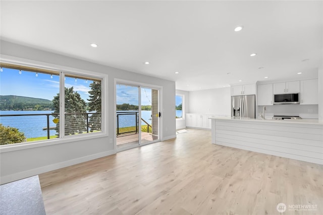 610 Northshore Dr Unit 6123, Bellingham, WA 98226 - unfurnished living room featuring light wood-type flooring, recessed lighting, and a water view