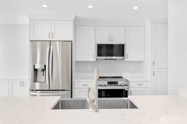 610 Northshore Dr Unit 6123, Bellingham, WA 98226 - kitchen featuring stainless steel appliances, white cabinetry, recessed lighting, and light stone countertops