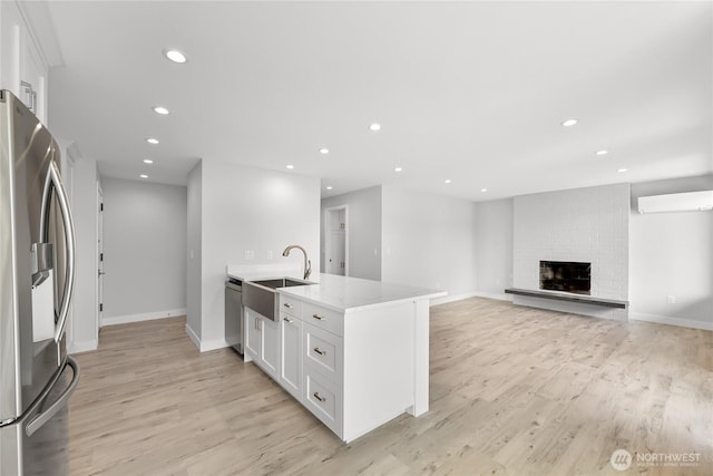 610 Northshore Dr Unit 6123, Bellingham, WA 98226 - kitchen with stainless steel appliances, light wood finished floors, white cabinets, recessed lighting, and a brick fireplace