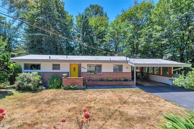 1515 NE 106th St, Seattle, WA 98125 - single story home featuring brick siding, driveway, a front yard, and an attached carport