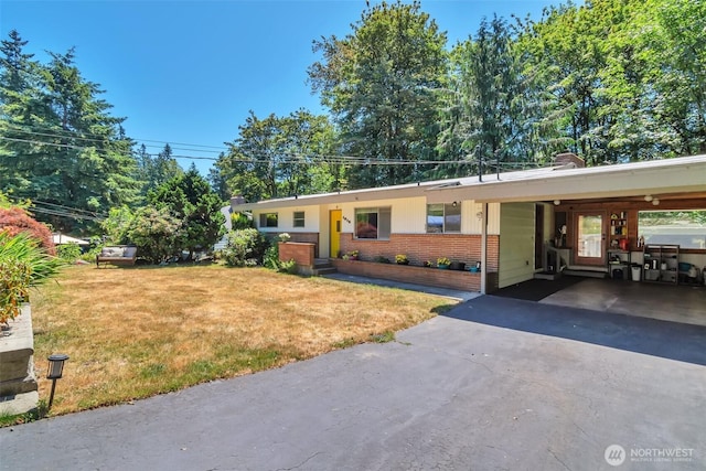 1515 NE 106th St, Seattle, WA 98125 - ranch-style home with an attached carport, a front lawn, brick siding, and asphalt driveway