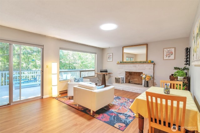 1515 NE 106th St, Seattle, WA 98125 - living area with wood finished floors, a fireplace, and a baseboard radiator