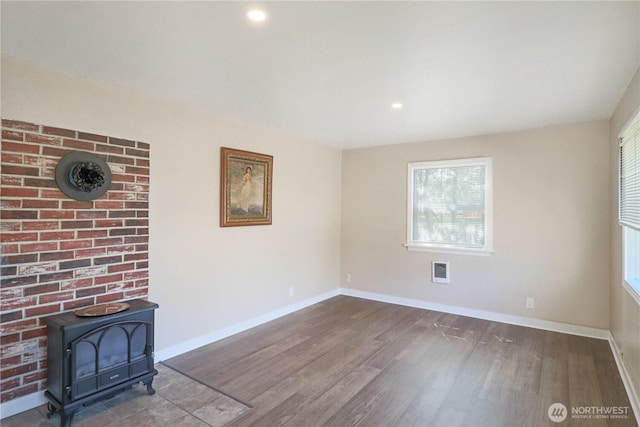 837 NW Duffy St, Chehalis, WA 98532 - unfurnished living room with a wood stove, wood finished floors, and recessed lighting