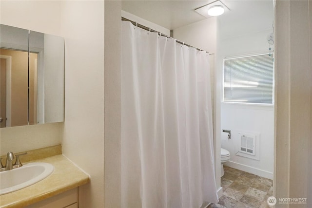 837 NW Duffy St, Chehalis, WA 98532 - full bathroom featuring vanity, heating unit, and a shower with shower curtain