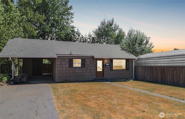 837 NW Duffy St, Chehalis, WA 98532 - ranch-style house with a shingled roof, a yard, asphalt driveway, an attached carport, and a chimney