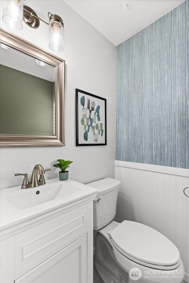 728 NW 189th Ln, Shoreline, WA 98177 - bathroom featuring wallpapered walls, a wainscoted wall, and vanity