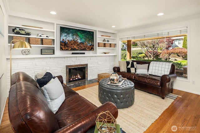 10261 NE 21st Pl, Bellevue, WA 98004 - living area with wood finished floors, crown molding, a fireplace, recessed lighting, and built in shelves