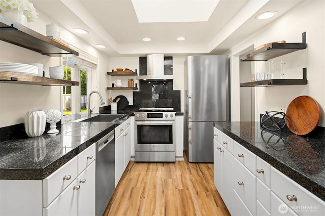 10261 NE 21st Pl, Bellevue, WA 98004 - kitchen featuring open shelves, stainless steel appliances, tile countertops, wall chimney range hood, and light wood-type flooring