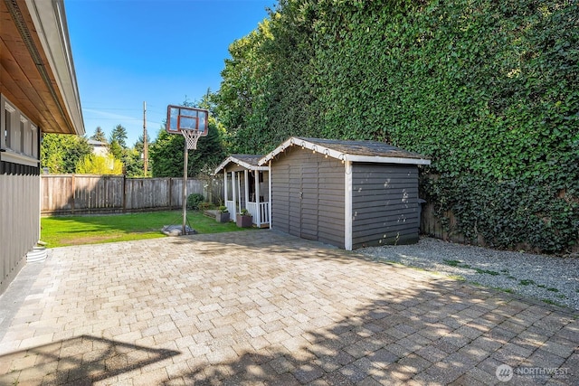 10261 NE 21st Pl, Bellevue, WA 98004 - fenced backyard with an outdoor structure and a patio