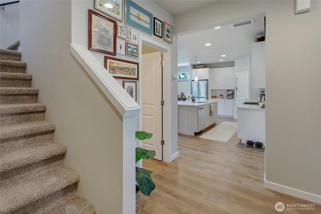15539 Bergh Ct SE, Yelm, WA 98597 - stairway featuring wood finished floors and recessed lighting