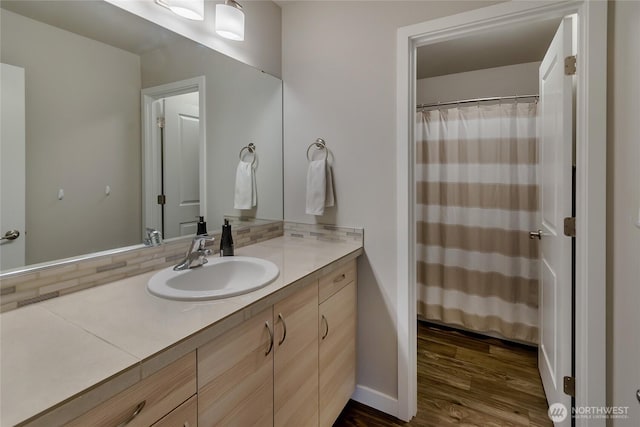 15539 Bergh Ct SE, Yelm, WA 98597 - bathroom with vanity, wood finished floors, and decorative backsplash