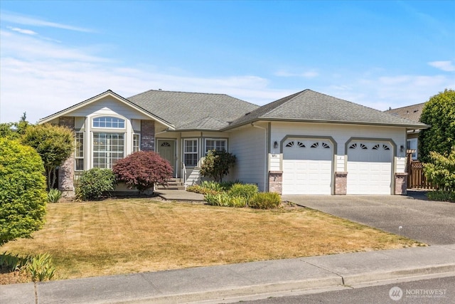 8051 283rd St NW, Stanwood, WA 98292 - ranch-style home featuring a garage, asphalt driveway, a front yard, brick siding, and roof with shingles