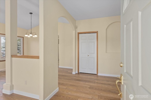 8051 283rd St NW, Stanwood, WA 98292 - entryway featuring wood finished floors, a chandelier, and arched walkways