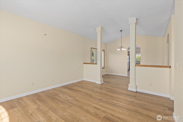 8051 283rd St NW, Stanwood, WA 98292 - unfurnished room with healthy amount of natural light, a chandelier, light wood-style floors, arched walkways, and vaulted ceiling