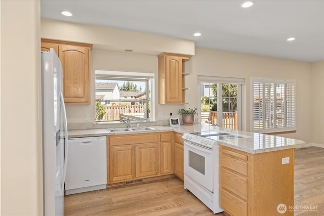 8051 283rd St NW, Stanwood, WA 98292 - kitchen with white appliances, light brown cabinetry, a peninsula, plenty of natural light, and recessed lighting