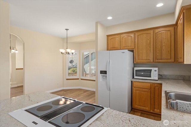 8051 283rd St NW, Stanwood, WA 98292 - kitchen with white appliances, a chandelier, light wood-type flooring, decorative light fixtures, and recessed lighting