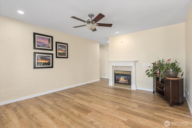 8051 283rd St NW, Stanwood, WA 98292 - unfurnished living room featuring a fireplace, ceiling fan, light wood finished floors, and recessed lighting
