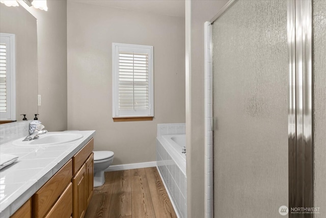 8051 283rd St NW, Stanwood, WA 98292 - full bath with wood finished floors, double vanity, a stall shower, and a garden tub