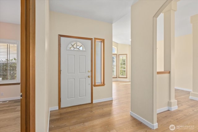 8051 283rd St NW, Stanwood, WA 98292 - foyer featuring light wood-style flooring and arched walkways