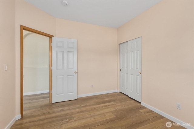 8051 283rd St NW, Stanwood, WA 98292 - unfurnished bedroom with wood finished floors and a closet