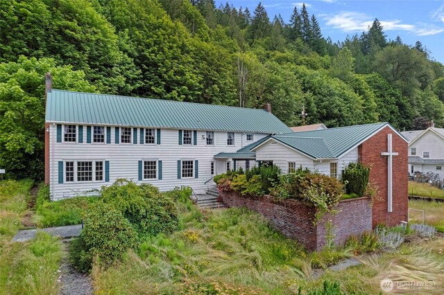 46372 E Main St, Concrete, WA 98237 - colonial home featuring a metal roof and a wooded view