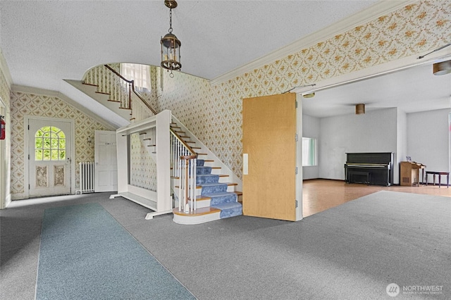 46372 E Main St, Concrete, WA 98237 - stairway with wallpapered walls, crown molding, plenty of natural light, carpet, and a textured ceiling